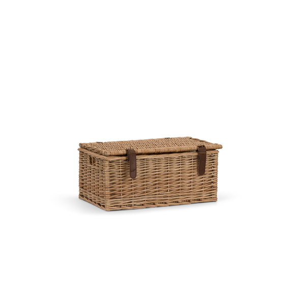 A rectangular woven wicker storage basket with a hinged lid and two dark brown leather strap closures, shown on a plain white background.