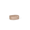 A small oval rattan storage basket with cutout handles, made from natural tan reed or wicker, shown on a plain white background.