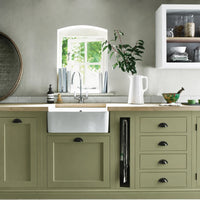 Olive green painted Henley kitchen cabinetry with oak worktops and a white farmhouse sink.