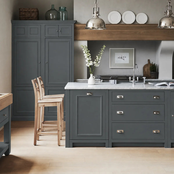 Chichester kitchen with cabinetry painted in Smoke Grey, featuring a central island and oak bar stools.
