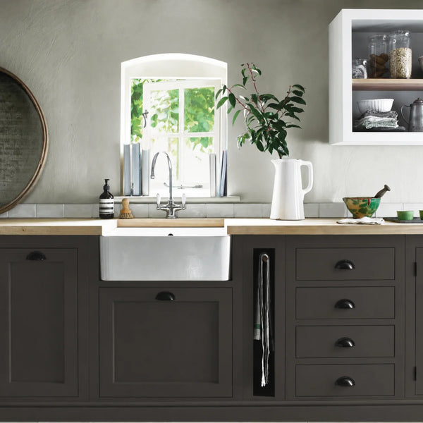 Walnut dark brown painted Henley kitchen cabinetry with oak worktops and a white farmhouse sink.