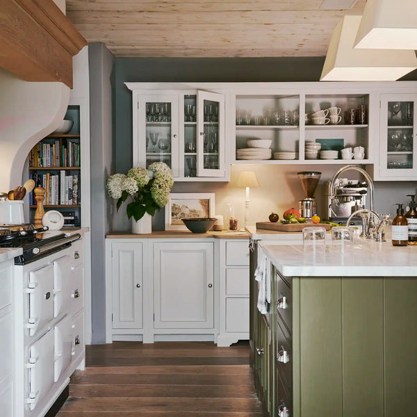 Chichester kitchen with shell white painted cabinetry, olive green island, white marble worktops and open shelving.