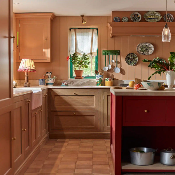 Henley country kitchen with oak cabinetry, terracotta walls and red painted island.