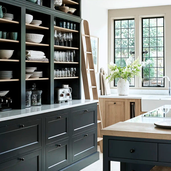 Henley kitchen with dark Constable Green painted tall shelving, oak details, library ladder and marble worktops.