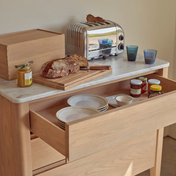 Borough freestanding oak kitchen cabinet with deep pan drawer open beneath a marble worktop.
