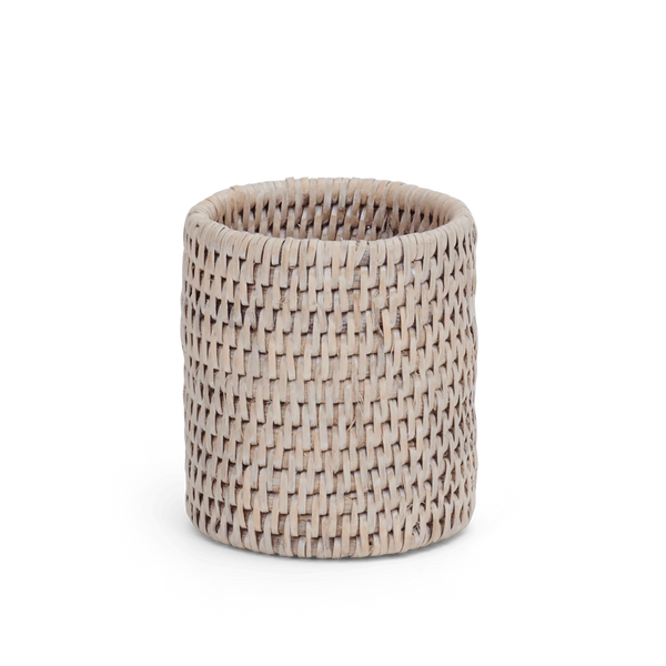 A small cylindrical woven round pen pot made from natural light brown reed or wicker, shown on a clean white background.
