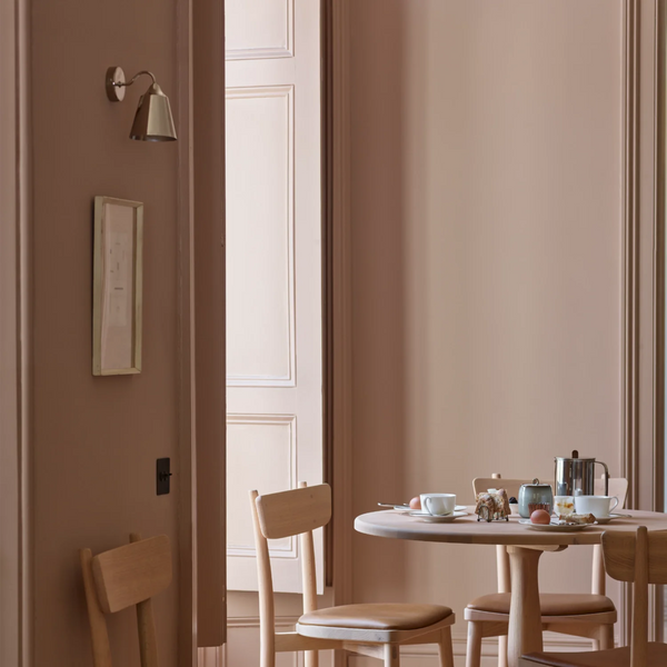 Belgrave nickel downlight wall light in blush pink kitchen with round oak dining table and breakfast selection