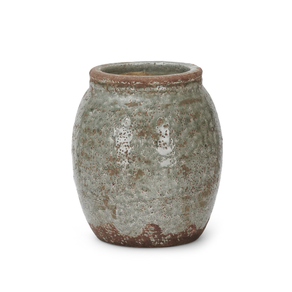 A small round ceramic pot with a textured, speckled glaze in muted green-gray and brown tones, shown on a plain white background.