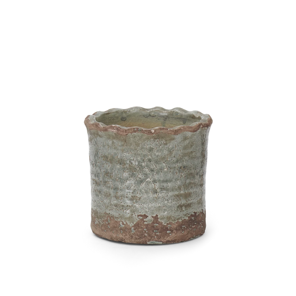 A small handmade ceramic pot with a scalloped rim, featuring a textured glaze that transitions from a muted sage green to a rustic reddish-brown base.