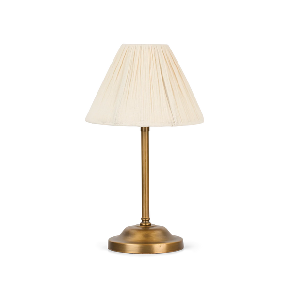 Cecile portable brass table lamp with scalloped linen shade on a white background