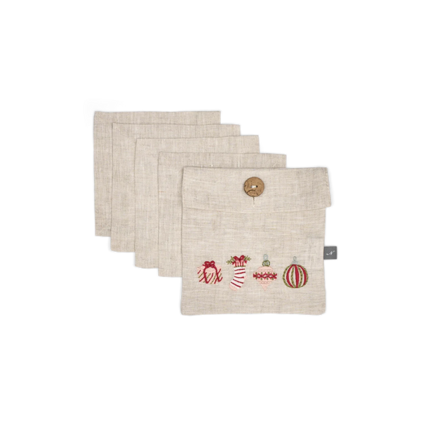 Four square beige linen napkins with a small wooden button on the front, decorated with embroidered Christmas motifs including a gift, candy cane, snowman, and ornament. The napkins are stacked slightly offset against a plain white background.