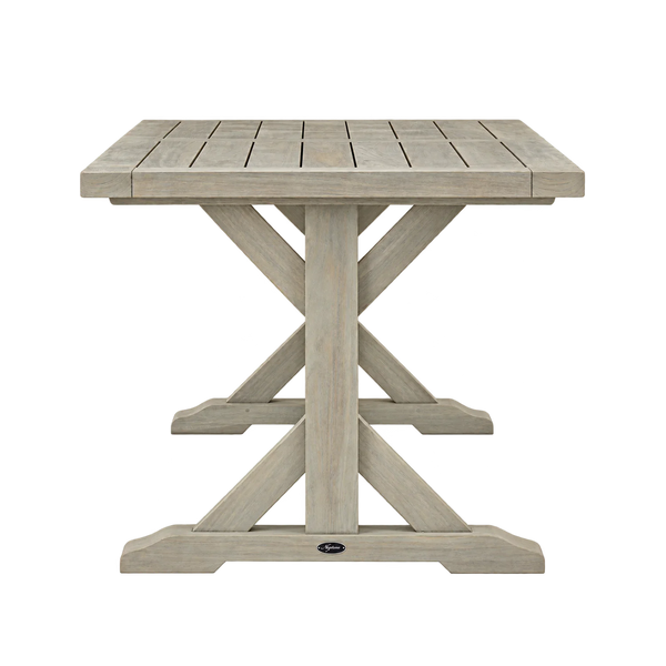 A square outdoor dining table with a light gray weathered finish, featuring a slatted top and an X-shaped pedestal base, shown against a plain white background.
