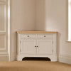 Henley 4ft Corner AV Cabinet in Silver Birch with oak top, styled in a softly lit neutral room corner.
