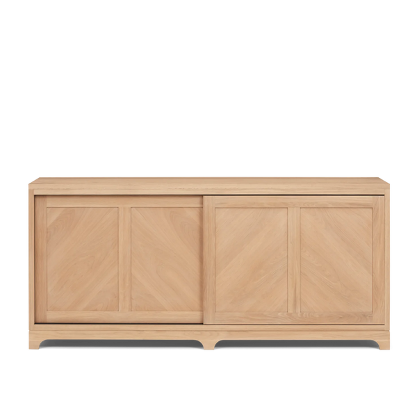 A light natural wood sideboard or credenza with three paneled doors and a sliding drawer on the right, shown against a plain white background.