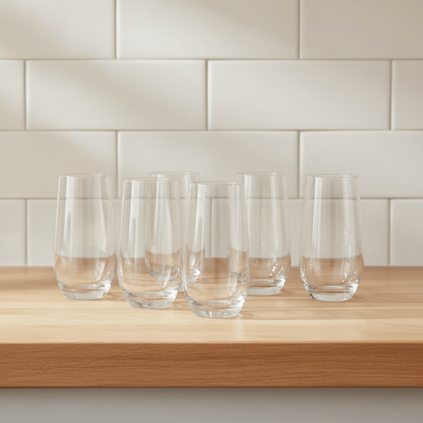 Some tall tumblers on a kitchen worksurface with tiled background