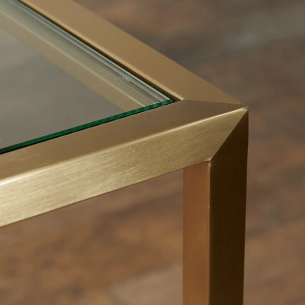 Close-up of a corner with gold frame and glass surface on a blurred background