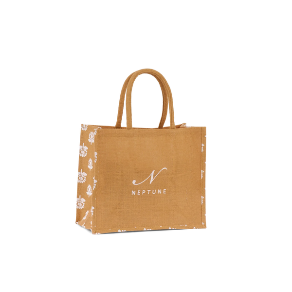 A small jute shopping bag with tan handles, featuring a white floral pattern on the sides and the white printed logo 'NEPTUNE' on the front, set against a plain white background.
