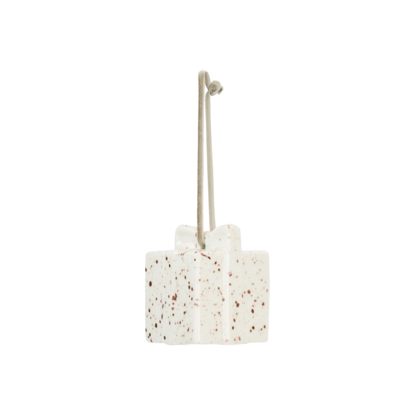 A ceramic hanging ornament shaped like a small gift box with a hanging loop, featuring a speckled off-white glaze with brown and reddish-brown flecks, isolated on a white background.