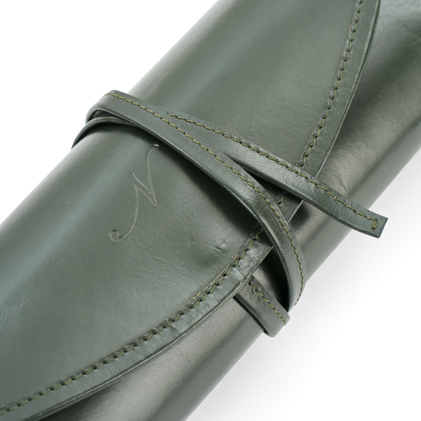 Close-up of a rolled olive green leather item secured with a matching wrap strap, showing fine stitching and a subtle embossed script detail on a white background.