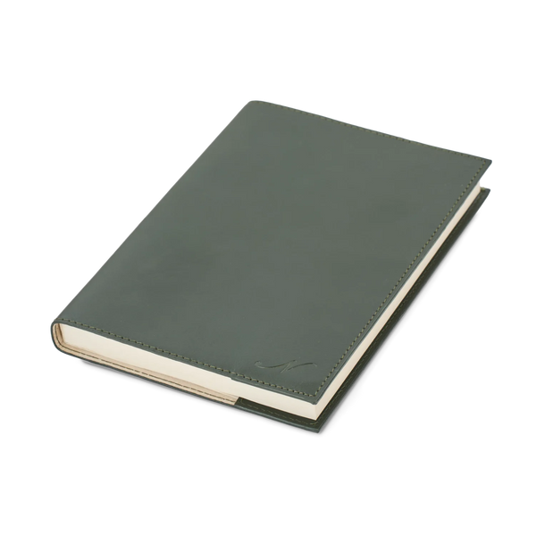 A dark olive green leather-bound notebook with cream-colored pages, shown at an angle on a clean white background.