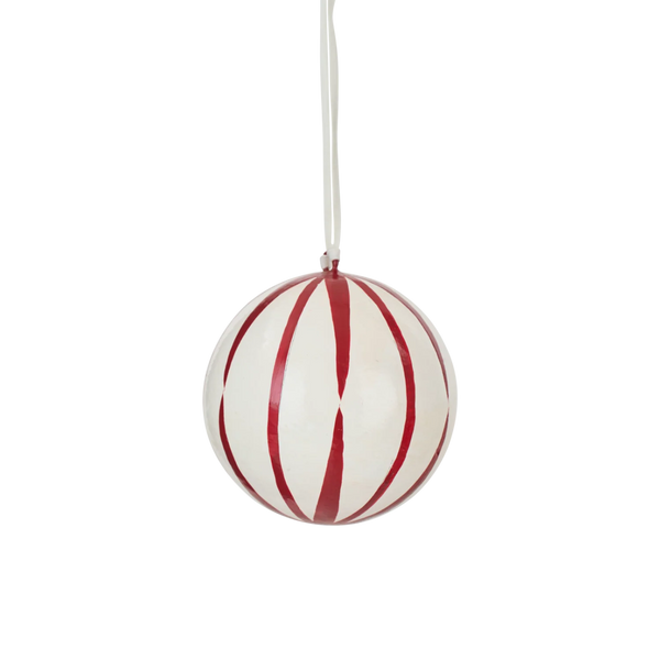 A spherical Christmas ornament with a glossy white finish, decorated with bold red vertical stripes, hanging from a thin white string against a solid white background.