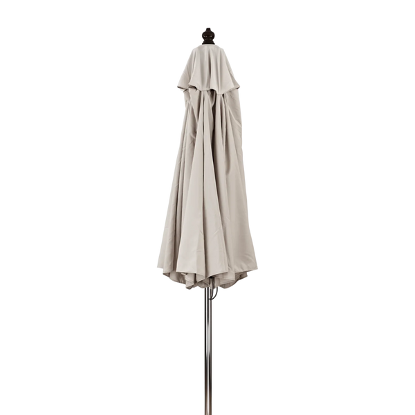 A folded patio umbrella canopy in a light beige or taupe color, displayed on a metal stand against a solid white background.