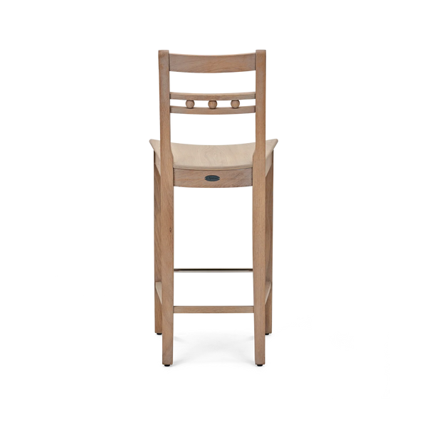 A wooden bar stool with a light oak finish, featuring a ladder-style backrest with three round wooden pegs and a small round metal emblem on the front of the seat, shown against a plain white background.