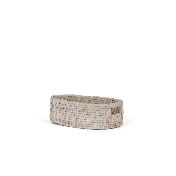 A small oval woven basket in a light beige or oatmeal tone, photographed on a clean white background.