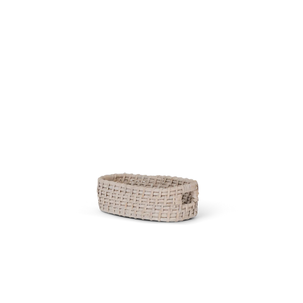 A small woven basket with a handle, made from light beige natural fibers, shown on a plain white background.