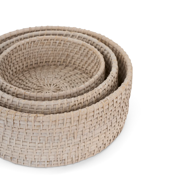 Three nested round woven baskets in a natural beige tone, photographed on a clean white background.