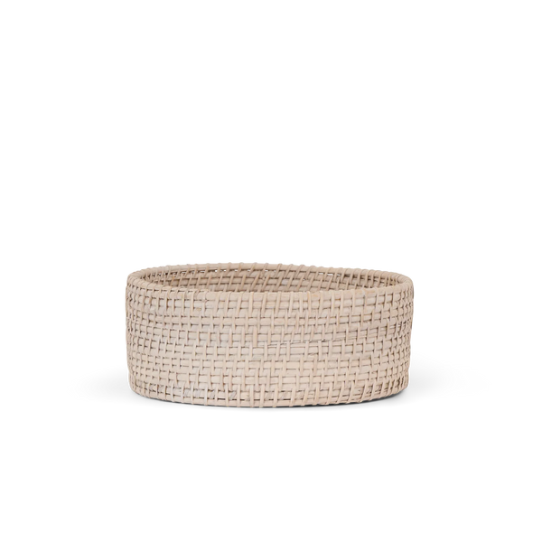 A round woven basket in a natural light beige tone, photographed against a clean white background.