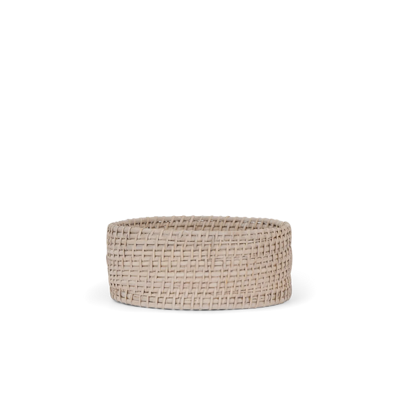 A round woven basket in a natural beige tone, shown against a solid white background.