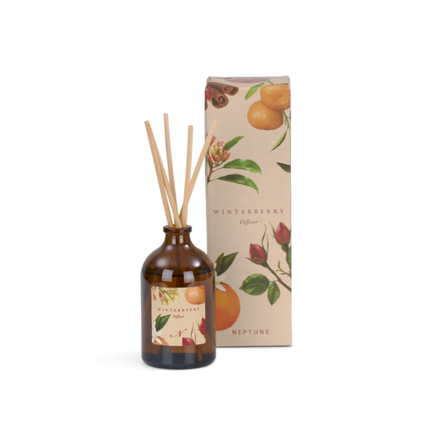 A reed diffuser bottle with amber glass and natural reeds sits beside its illustrated product box on a white background.