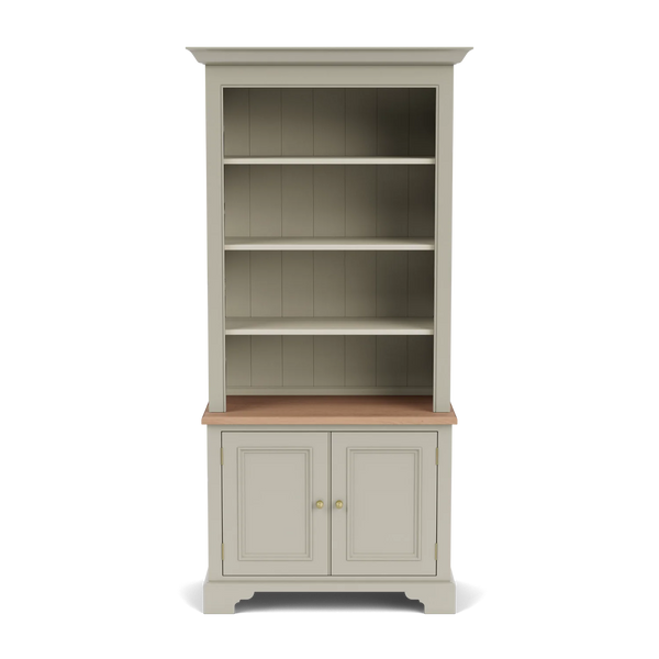 Front view of the Chichester 3ft bookcase, showing open shelving above a natural oak surface, lower panelled cupboard doors and classic painted detailing.