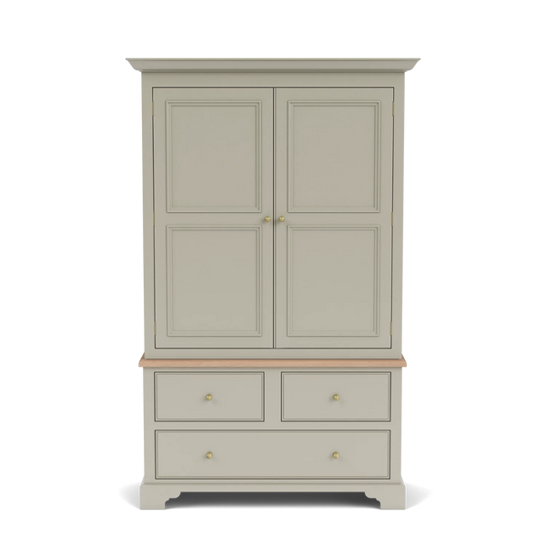 A tall double-door armoire cabinet in a warm light gray or greige finish, featuring a natural wood apron and small brass knobs, shown against a plain white background.