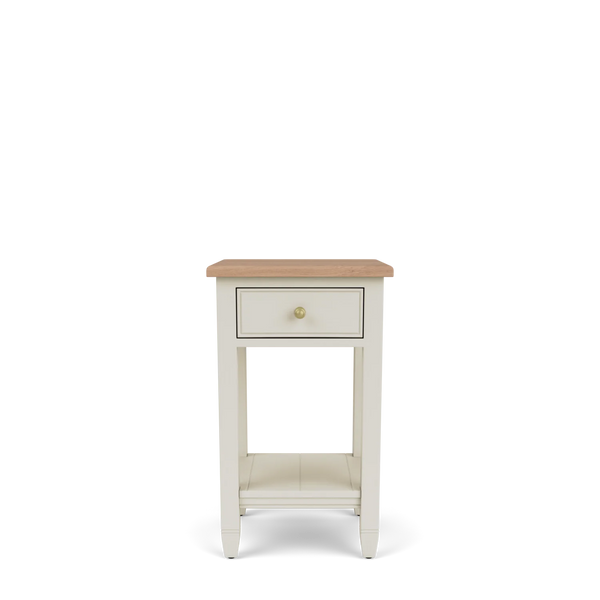 Front view of the Chichester open bedside cabinet, showing its natural oak top, single drawer with brass handle, open lower shelf and painted timber frame.