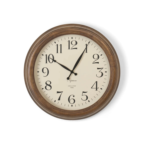 A round wall clock with a dark brown wood-grain frame and a cream-colored dial, featuring black Arabic numerals and hands, shown against a plain white background.