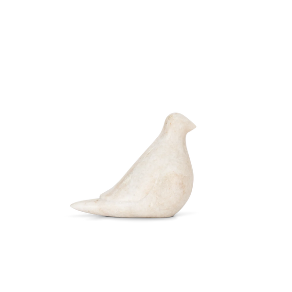 A minimalist, sculptural bird figurine made of textured off-white stone, shown in profile against a solid white background.