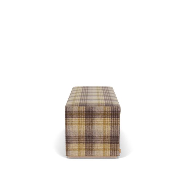 Side view of the Neptune Renewed Eloise ottoman in Harris Tweed Fig, showing its deep padded profile and tailored checked tweed upholstery.
