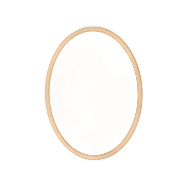 An oval wall mirror with a thin, light natural wood frame, centered on a solid white background.