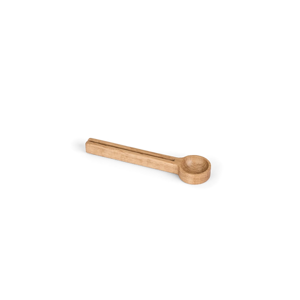 A small wooden spoon with a rectangular handle and a shallow oval bowl, shown on a plain white background.