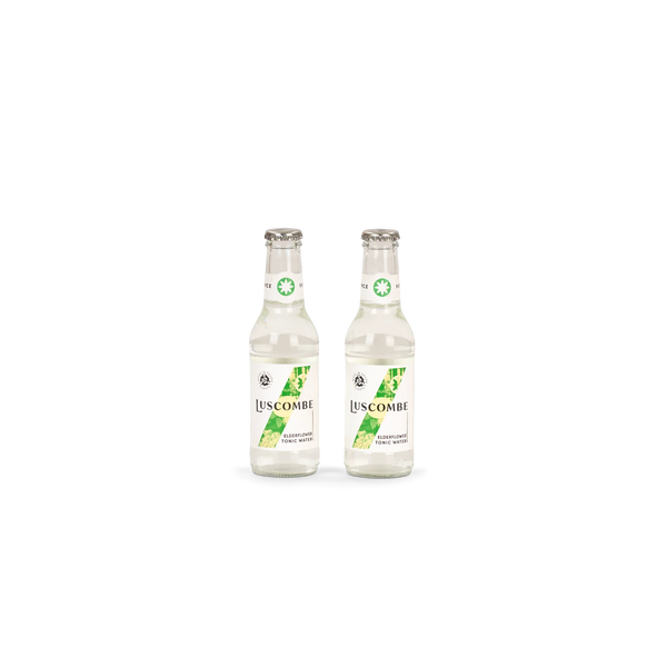 Two clear glass bottles of Luscombe Lemon Lime Tonic Water with white labels and green leaf graphics, shown side by side on a plain white background.