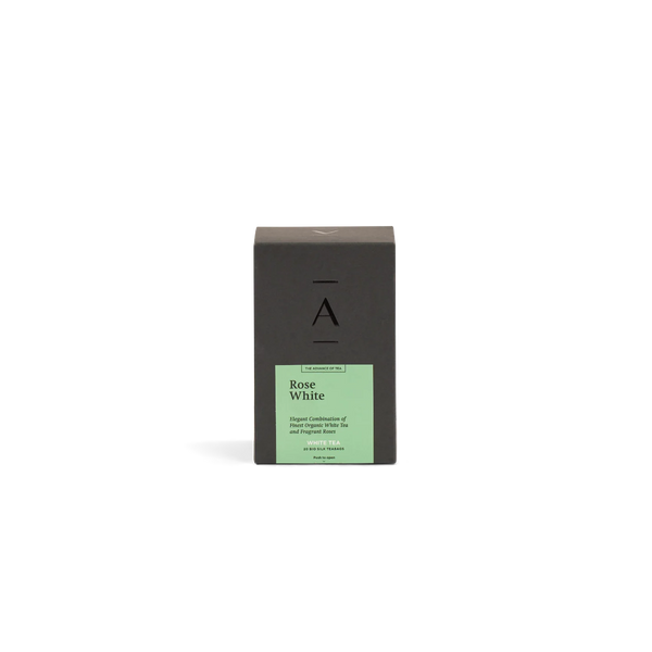 A tall rectangular dark charcoal box with a pale green label reading 'Rose White' white tea centered on a white background.